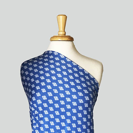 rayon lycra fabric in a blue & white medallion print draped over a mannequin